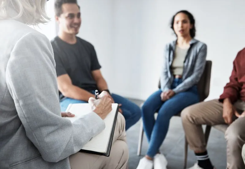 Therapist working with patients: Psychosis Treatment in Queens