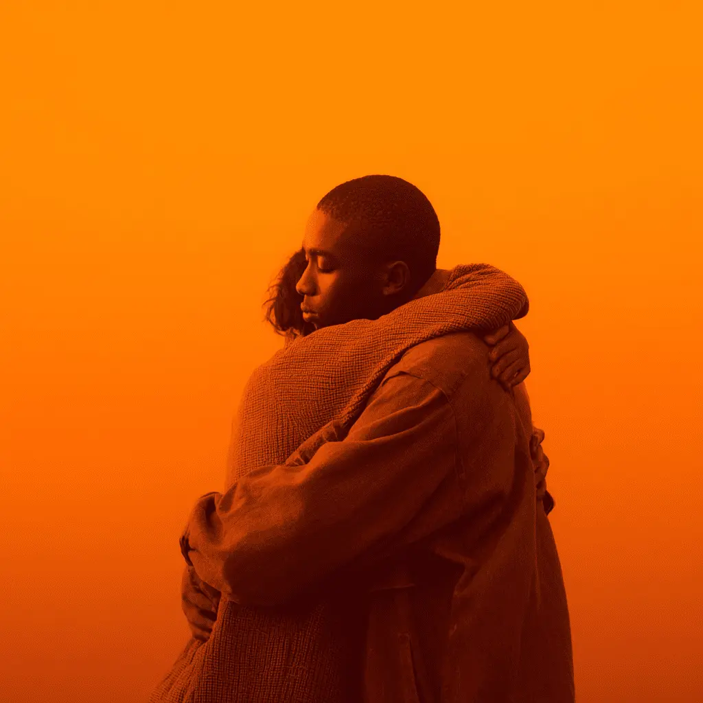 A heartfelt hug between two people in soft orange light, symbolizing empathy, support, and emotional connection.
