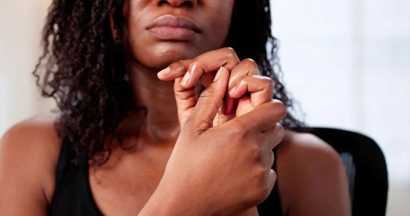 A close-up of a person nervously fidgeting with their fingers, highlighting the anxiety often experienced by adults with ADHD. This image underscores the need for the best ADHD medication for adults with anxiety to address both symptoms.